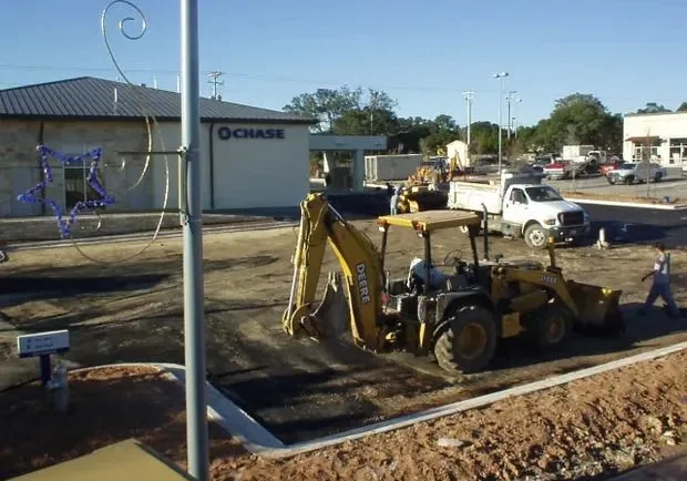 A bulldozer is working in front of a building.